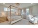 Sunlit main bedroom featuring a four-poster bed, neutral tones and many windows at 8039 Mcconnell Rd, Denver, NC 28037