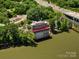 Aerial shot of the Pump House on the river, showcasing its unique location by a bridge and lush greenery at 807 Herrons Ferry Rd, Rock Hill, SC 29730