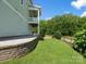 Backyard with stone retaining wall, pavers, green grass, and privacy fence at 807 Herrons Ferry Rd, Rock Hill, SC 29730