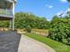 Beautifully landscaped backyard with stone pavers, green grass, and wooded views at 807 Herrons Ferry Rd, Rock Hill, SC 29730