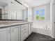 Bright bathroom features a double vanity, soaking tub, and large window with natural light at 807 Herrons Ferry Rd, Rock Hill, SC 29730