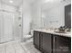 Bathroom with a shower, dark wood vanity with granite countertop, and ample space at 807 Herrons Ferry Rd, Rock Hill, SC 29730