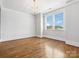 Bright bedroom with hardwood floors, shiplap accent wall, modern chandelier, and large window at 807 Herrons Ferry Rd, Rock Hill, SC 29730