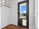 Entryway featuring hardwood floors, white shiplap walls, and a modern black front door with glass at 807 Herrons Ferry Rd, Rock Hill, SC 29730