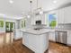 Modern kitchen featuring white cabinets, a large island, stainless steel appliances and hardwood floors at 807 Herrons Ferry Rd, Rock Hill, SC 29730
