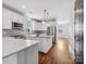 Bright modern kitchen with stainless appliances, pendant lights, and hardwood floors, flowing into the living space at 807 Herrons Ferry Rd, Rock Hill, SC 29730
