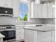 Modern kitchen features white cabinets, gray backsplash, stainless appliances, and stylish pendant lighting at 807 Herrons Ferry Rd, Rock Hill, SC 29730
