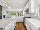 Modern kitchen featuring white cabinets, a large island, stainless steel appliances and hardwood floors at 807 Herrons Ferry Rd, Rock Hill, SC 29730