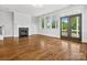 Sunlit living room features hardwood floors, a cozy fireplace, and backyard access at 807 Herrons Ferry Rd, Rock Hill, SC 29730
