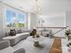 Bright living room with modern furnishings, a statement chandelier, and an abundance of natural light at 807 Herrons Ferry Rd, Rock Hill, SC 29730