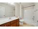Traditional bathroom showcasing a vanity with wood cabinets and a shower-tub combo at 8230 Viewpoint Ln, Cornelius, NC 28031