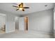 Bedroom with neutral walls, carpet, ceiling fan, and closet at 8230 Viewpoint Ln, Cornelius, NC 28031