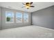 Bedroom filled with natural light from several windows and a ceiling fan at 8230 Viewpoint Ln, Cornelius, NC 28031
