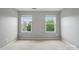 Neutral bedroom with a view of the outdoors provided by two windows with window treatments at 8230 Viewpoint Ln, Cornelius, NC 28031