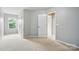 Bright bedroom features neutral walls, carpet, and a window providing natural light at 8230 Viewpoint Ln, Cornelius, NC 28031