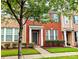 Charming two-story red brick townhouse with well-maintained landscaping and inviting front entrance at 8230 Viewpoint Ln, Cornelius, NC 28031