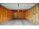 Empty garage with exposed framing, lighting, and a concrete floor at 8230 Viewpoint Ln, Cornelius, NC 28031