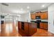 Open-concept kitchen with center island, wooden cabinets, and black appliances at 8230 Viewpoint Ln, Cornelius, NC 28031