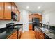 Modern kitchen with granite countertops, stainless steel sink, and wooden cabinets at 8230 Viewpoint Ln, Cornelius, NC 28031