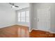 Bright living room with hardwood floors, a ceiling fan, and ample natural light at 8230 Viewpoint Ln, Cornelius, NC 28031