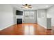 Comfortable living room with fireplace, hardwood floors, and ample light from windows at 8230 Viewpoint Ln, Cornelius, NC 28031