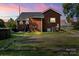 Brick home's backyard features a seating area, partial grass, and convenient parking at 85 Ruritan Park Rd, Stony Point, NC 28678