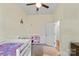 Carpeted bedroom with a lofted bed, a play kitchen, and an open door at 85 Ruritan Park Rd, Stony Point, NC 28678