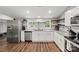 Modern kitchen with white cabinets, granite countertops, and stainless steel appliances at 85 Ruritan Park Rd, Stony Point, NC 28678
