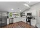 Bright kitchen features stainless steel appliances, white cabinets, granite countertops, and subway tile backsplash at 85 Ruritan Park Rd, Stony Point, NC 28678