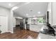 Bright open kitchen with stainless steel appliances, granite countertops, and white cabinets at 85 Ruritan Park Rd, Stony Point, NC 28678