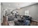 Bright living room with hardwood floors, neutral paint, and an open floor plan with a view of the kitchen at 85 Ruritan Park Rd, Stony Point, NC 28678