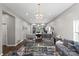 Spacious living area with hardwood floors, modern lighting, and an open layout to the kitchen at 85 Ruritan Park Rd, Stony Point, NC 28678