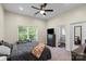 Primary bedroom with large windows, neutral color palette, and an en-suite bathroom at 85 Ruritan Park Rd, Stony Point, NC 28678