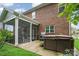 Large backyard featuring a screened-in porch, brick siding, and a private hot tub at 9032 Cornflower Dr, Harrisburg, NC 28075