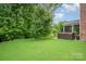 Manicured backyard featuring a hot tub and screened porch for outdoor relaxation and entertainment at 9032 Cornflower Dr, Harrisburg, NC 28075