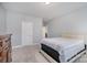 Bedroom featuring light blue walls, plush carpeting, white trim, and a wooden dresser at 9032 Cornflower Dr, Harrisburg, NC 28075