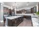Spacious kitchen features granite countertops, stainless appliances, and dark wood cabinetry at 9032 Cornflower Dr, Harrisburg, NC 28075