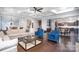 Open-concept living area with hardwood floors, coffered ceilings, and seamless access to the dining area at 9032 Cornflower Dr, Harrisburg, NC 28075