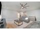 Spacious upstairs living room with comfortable gray couches and ceiling fan at 9032 Cornflower Dr, Harrisburg, NC 28075