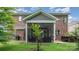 The backyard showcases the screened porch and a hot tub, perfect for outdoor enjoyment at 9032 Cornflower Dr, Harrisburg, NC 28075