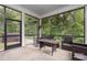 Inviting screened porch with comfortable seating, heater, and views of the lush backyard at 9032 Cornflower Dr, Harrisburg, NC 28075