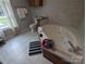Bright bathroom featuring a luxurious jacuzzi tub, pristine white tile, and ample natural light at 936 New Camp Creek Church Rd # 11, Kings Mountain, NC 28086