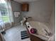 Bright bathroom featuring a tiled tub and a large window with natural light at 936 New Camp Creek Church Rd # 11, Kings Mountain, NC 28086