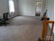 Large bedroom with neutral carpet, light walls, and an open doorway at 936 New Camp Creek Church Rd # 11, Kings Mountain, NC 28086