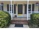 Charming front porch with brick steps, white railings, and a brown front door at 936 New Camp Creek Church Rd # 11, Kings Mountain, NC 28086