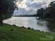 Picturesque lake view from a lush green lawn with mature trees at 936 New Camp Creek Church Rd # 11, Kings Mountain, NC 28086