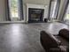 Open living room space with fireplace and gray tile flooring at 936 New Camp Creek Church Rd # 11, Kings Mountain, NC 28086