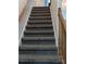 Carpeted staircase with wooden handrail and white trim at 936 New Camp Creek Church Rd # 11, Kings Mountain, NC 28086