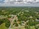 Aerial view shows the home nestled in a lush green neighborhood surrounded by mature trees at 1070 Nc 182 Hwy, Lincolnton, NC 28092