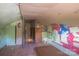 A unique attic space is shown, complete with colorful artwork and lots of character at 1070 Nc 182 Hwy, Lincolnton, NC 28092